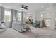 Relaxing bonus room with plush seating, modern decor, and a staircase leading to another level at 72 Cultivator Ct, Angier, NC 27501