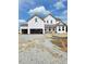 New construction home featuring a two-car garage and a covered front porch at 72 Cultivator Ct, Angier, NC 27501