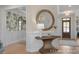 Entryway with decorative mirror and table, leading to dining room and front door at 72 Cultivator Ct, Angier, NC 27501