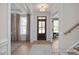 Bright foyer with a wood front door, white trim, and hardwood flooring at 72 Cultivator Ct, Angier, NC 27501