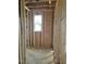 Framing of a small room with a window showcasing the initial construction phase and natural light source at 72 Cultivator Ct, Angier, NC 27501