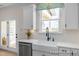 Kitchen showcasing farmhouse sink, white cabinets, stainless steel dishwasher and a view from the window at 72 Cultivator Ct, Angier, NC 27501