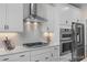 Close up of kitchen showcasing stainless steel appliances, white cabinets, and a stylish backsplash at 72 Cultivator Ct, Angier, NC 27501