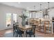 Eat-in kitchen with hardwood floors, bar seating, and stainless steel appliances at 72 Cultivator Ct, Angier, NC 27501