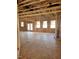 Unfinished room featuring wood framing, several windows for natural light and an open floor plan at 72 Cultivator Ct, Angier, NC 27501