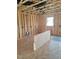 Unfinished room showing wood framing, exposed ceiling beams, and natural light at 72 Cultivator Ct, Angier, NC 27501