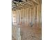 Spacious, unfinished living room featuring wood framing, exposed wiring, and open concept at 72 Cultivator Ct, Angier, NC 27501