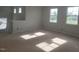 Sun-drenched living room featuring many windows and neutral walls at 72 Cultivator Ct, Angier, NC 27501