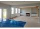 Spacious living room with a fireplace, built-in shelving, and a wall of bright windows at 72 Cultivator Ct, Angier, NC 27501