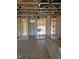 Unfinished living room showcasing the wood frame, exposed ceiling beams, and natural light at 72 Cultivator Ct, Angier, NC 27501