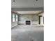 Bright living room featuring a fireplace, built-in cabinets, and large windows for ample natural light at 72 Cultivator Ct, Angier, NC 27501