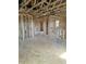 Spacious unfinished room highlighting wood framing, exposed duct work, and natural light at 72 Cultivator Ct, Angier, NC 27501