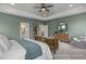 Main bedroom with a decorative tray ceiling, elegant furnishings, and an en-suite bathroom entrance at 72 Cultivator Ct, Angier, NC 27501