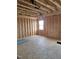 Wood-framed interior with a window, plywood subfloor and exposed beams showcasing the potential and construction stage at 72 Cultivator Ct, Angier, NC 27501