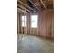 Framed room featuring exposed construction, two windows and open space, highlighting its potential and natural light at 72 Cultivator Ct, Angier, NC 27501