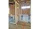 Framed shower area with a new shower insert showing construction progress and plumbing access points at 72 Cultivator Ct, Angier, NC 27501