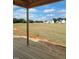 A picturesque view from the porch overlooking a field and the neighborhood in the distance underneath a partly cloudy sky at 72 Cultivator Ct, Angier, NC 27501