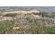 A high up aerial view showing the tree coverage, surrounding farms, and neighboring homes at 7214 Southern Trl, Chapel Hill, NC 27516