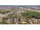 Aerial view of the property and surrounding wooded acreage showing the roof and driveway at 7214 Southern Trl, Chapel Hill, NC 27516