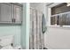 Bathroom featuring a decorative shower curtain, white wainscoting, and updated gray cabinets at 7214 Southern Trl, Chapel Hill, NC 27516