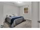 Cozy bedroom featuring gray walls and carpet, with a window that brings in natural light at 7214 Southern Trl, Chapel Hill, NC 27516