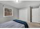 Bedroom with double door closet, carpet flooring and natural light from the window at 7214 Southern Trl, Chapel Hill, NC 27516