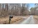 View of the long gravel driveway at 7214 Southern Trl, Chapel Hill, NC 27516
