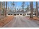 A ranch style house with a long asphalt driveway and light yellow vinyl siding and black shutters at 7214 Southern Trl, Chapel Hill, NC 27516