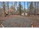 Gravel front yard with home in the background surrounded by mature trees at 7214 Southern Trl, Chapel Hill, NC 27516