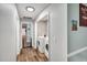 Hallway with wood look floors, showing the laundry room and access to the stairwell at 7214 Southern Trl, Chapel Hill, NC 27516