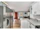 Open kitchen view with stainless steel fridge, marble countertops, and breakfast nook at 7214 Southern Trl, Chapel Hill, NC 27516