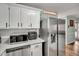 Updated kitchen showcases stainless steel appliances, white cabinets, and marble countertops at 7214 Southern Trl, Chapel Hill, NC 27516