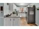 A modern white kitchen with stainless steel appliances and marble countertops at 7214 Southern Trl, Chapel Hill, NC 27516