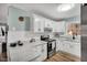 Bright kitchen features white cabinetry, stainless steel appliances, and marble countertops at 7214 Southern Trl, Chapel Hill, NC 27516