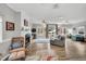 Spacious living room with wood floors, a fireplace, and multiple windows looking to the exterior of the house at 7214 Southern Trl, Chapel Hill, NC 27516