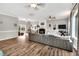 Spacious living room with wood floors, large windows, a gray sofa and a fireplace at 7214 Southern Trl, Chapel Hill, NC 27516