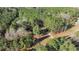 Aerial shot of the property surrounded by trees and other wooded foliage at 749 Fred Royster Rd, Henderson, NC 27537