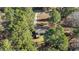 A view of the wooded property with a house and outbuilding in the center at 749 Fred Royster Rd, Henderson, NC 27537