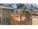 View of the wooden back porch with wooden railings and barbecue at 749 Fred Royster Rd, Henderson, NC 27537