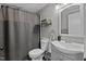 Cozy bathroom featuring a shower with gray curtain, a white toilet and sink vanity at 749 Fred Royster Rd, Henderson, NC 27537