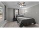 Well-lit bedroom featuring neutral decor, two windows with outside view and carpeted floor at 749 Fred Royster Rd, Henderson, NC 27537