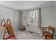 Bright bedroom with a window view, gray walls, and a learning station with easel at 749 Fred Royster Rd, Henderson, NC 27537