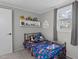 Cozy bedroom with a twin bed, window view, and a shelf of toys on the wall at 749 Fred Royster Rd, Henderson, NC 27537