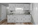 Functional kitchen with white cabinets and black hardware, complemented by sleek countertop appliances at 749 Fred Royster Rd, Henderson, NC 27537