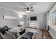 Cozy living room with a ceiling fan, wood floors, neutral paint, and large window views at 749 Fred Royster Rd, Henderson, NC 27537