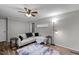 Inviting living room with modern ceiling fan, wood floors, neutral walls, and a comfortable couch at 749 Fred Royster Rd, Henderson, NC 27537