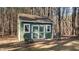 The outbuilding on the property is painted green with white trim and has a metal roof at 749 Fred Royster Rd, Henderson, NC 27537