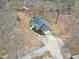 An aerial view showcases a well-situated home with a winding driveway and mature landscaping at 8724 Ten Ten Rd, Raleigh, NC 27603