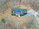 A serene aerial view of a beautiful home nestled among mature trees and well-kept grounds at 8724 Ten Ten Rd, Raleigh, NC 27603