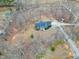 From above, a serene house is surrounded by mature trees and a winding driveway at 8724 Ten Ten Rd, Raleigh, NC 27603
